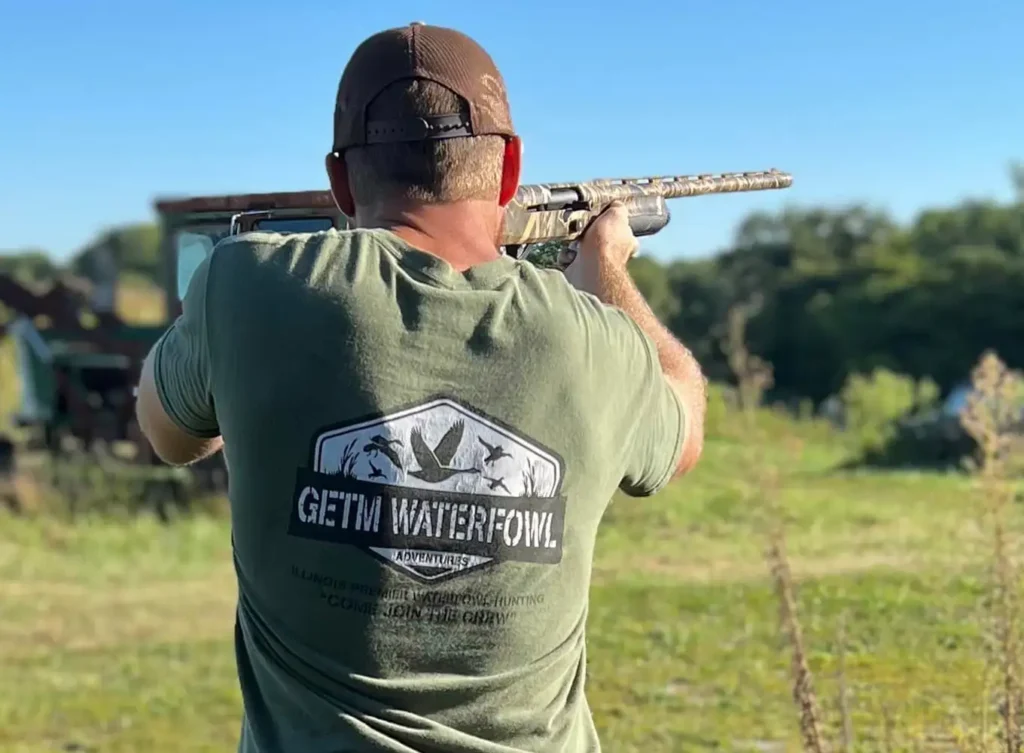 man holding a waterfowl hunting rifle wearing some GETM Waterfowl gear - Arkansas and Southern Illinois