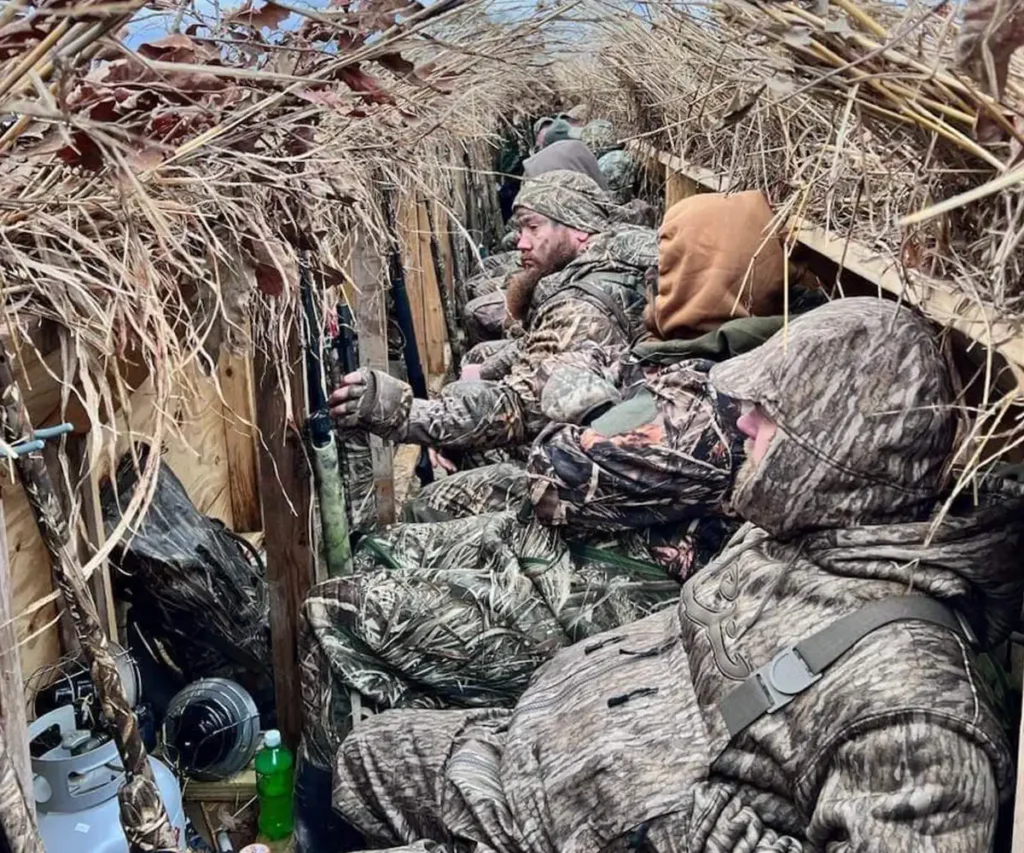 hunters hunkering down in a hunting blind for waterfowl hunting season